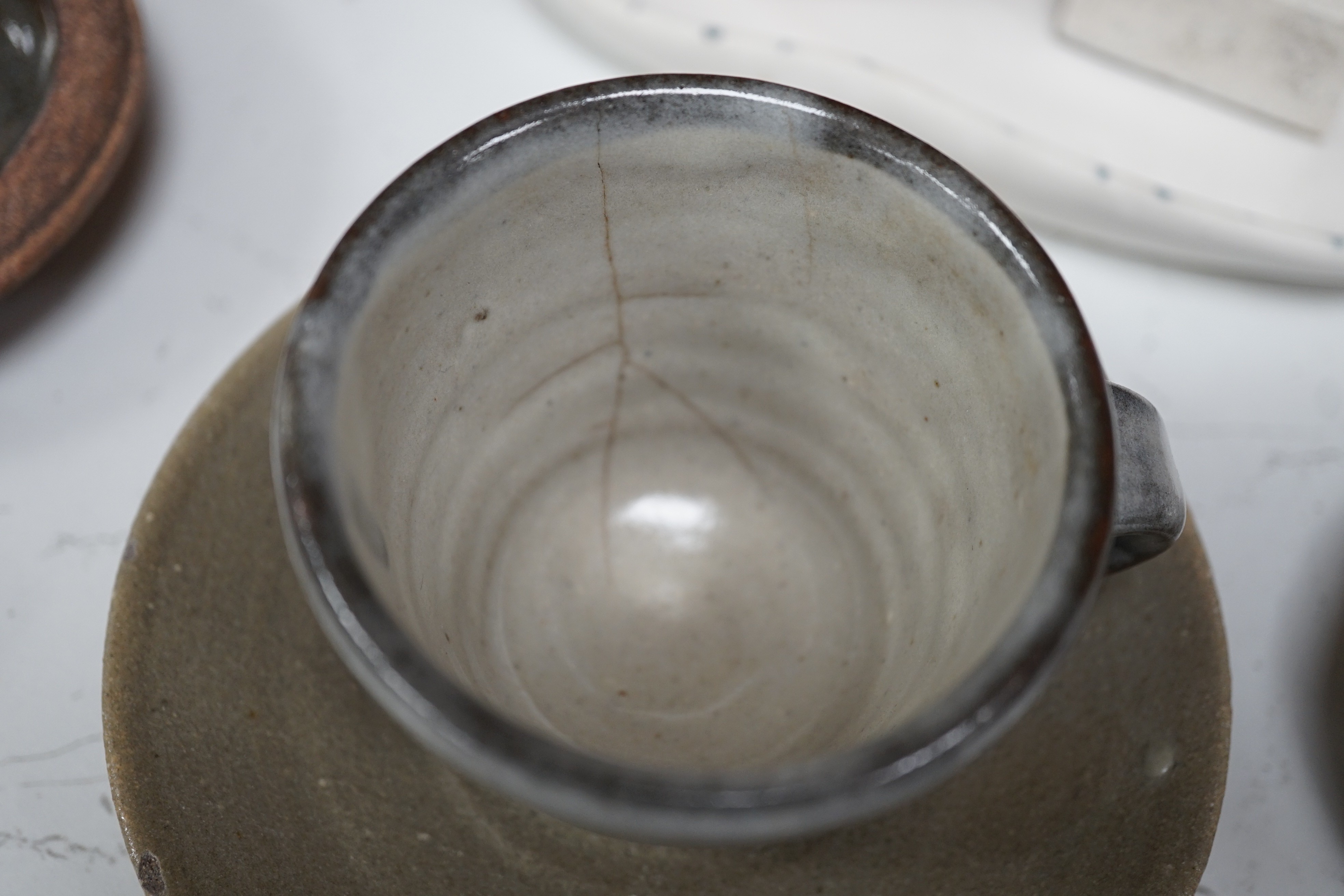 A group of studio pottery including St. Ives Leach pottery jug two dishes and a saucer